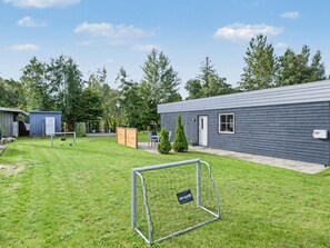 A residential property with a well-maintained lawn, a metal soccer goal, and a small wooden shed. - "Nina" - 600m from the sea by Interhome (Væggerløse)
