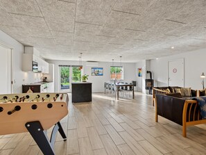 A spacious living area with a foosball table, a sofa, and a dining table with chairs. - "Nina" - 600m from the sea by Interhome (Væggerløse)