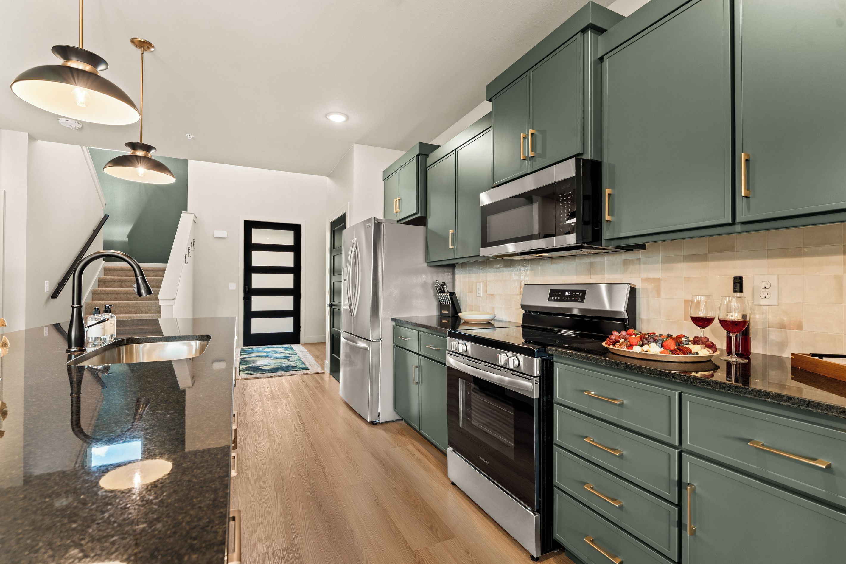 Fully equipped kitchen with stainless steel appliances and plenty of counter space for preparing group meals.