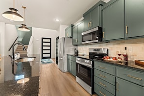 Fully equipped kitchen with stainless steel appliances and plenty of counter space for preparing group meals.