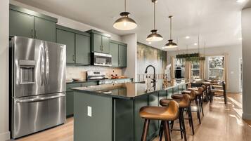 Pull up a stool at the oversized kitchen island for breakfast, snacks, or conversation.