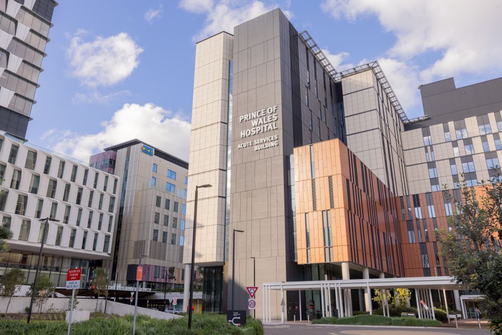 A modern building with signage for 'Prince of Wales Hospital Acute Services Building.'