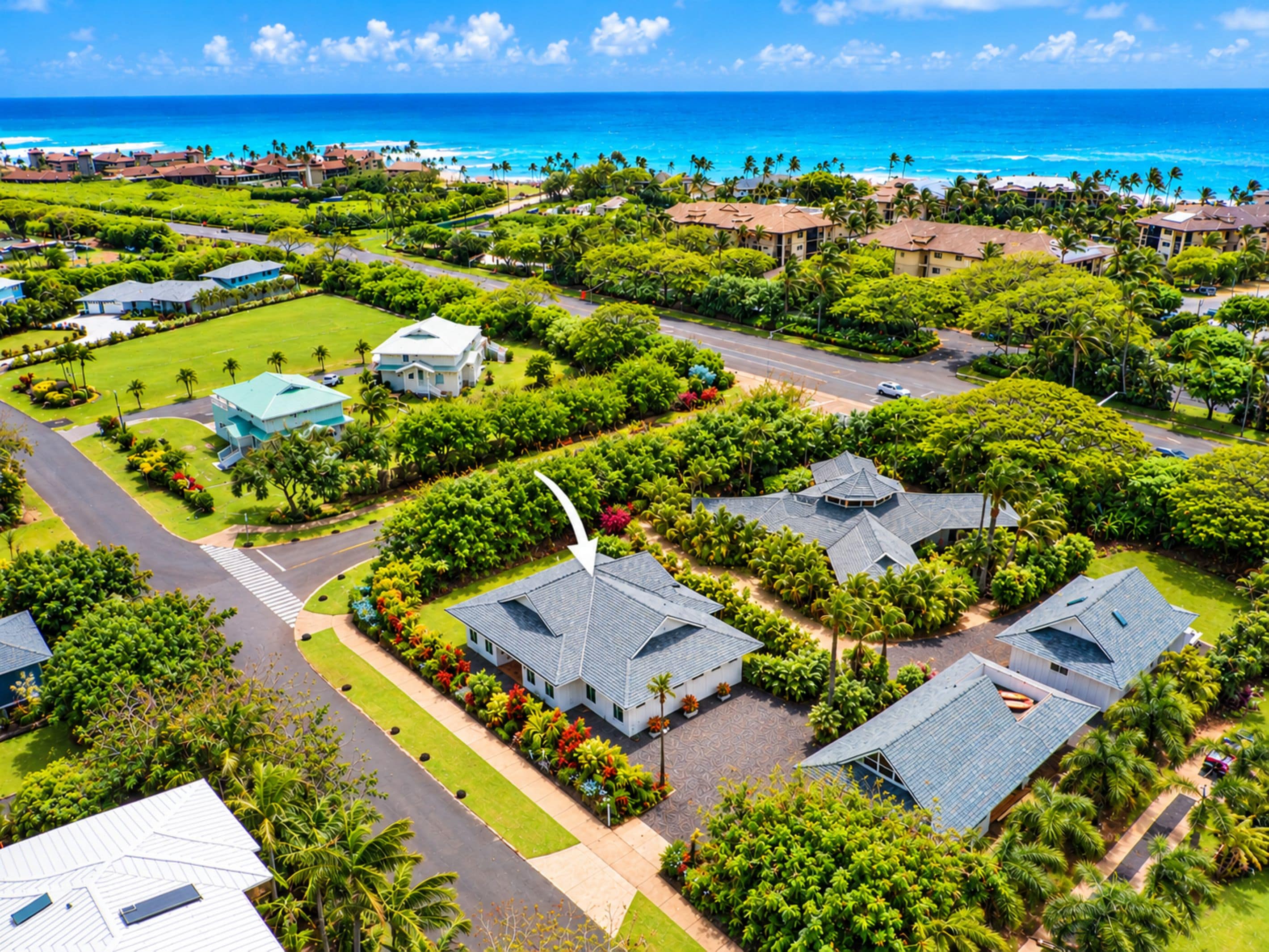 An aerial view of a residential area with houses, roads, and a coastline.