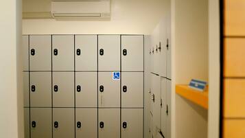 A row of lockers with numbers and a wheelchair accessibility sign.