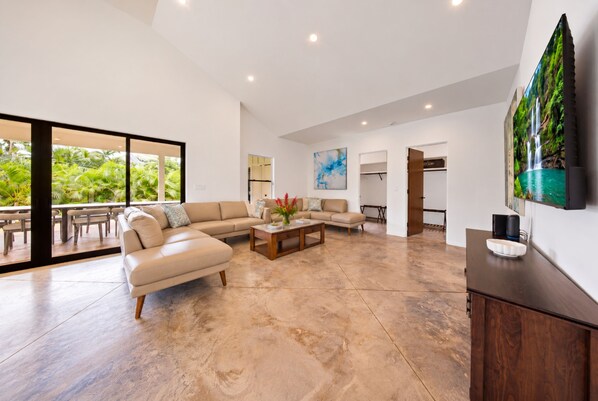 Spread out, unwind and enjoy a spacious living room framed by lush tropical greenery. - BRAND NEW Poipu Estate - Sleeps 8-16 - Full AC - 4 Ensuites - Poipu Beach Club (Koloa)