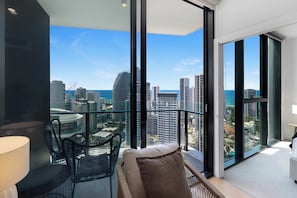 Living Room with Balcony Access
Enjoy open-plan living with incredible skyline vistas right from your seat. Glass sliding doors bring in bright sunlight and lead straight to the balcony. - Luxe 2BR @ The Star | Ocean+River Views, Pool, Gym (Broadbeach)