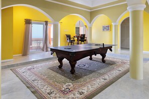 A billiards table in a room with yellow walls and a patterned carpet. - Hospitality Expert VSV 9BR Chef Pool (Montego Bay)
