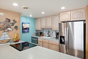 A kitchen with a stainless steel refrigerator, a toaster, and a coffee maker. - 2nd Floor Oceanfront 1BD with Panoramic Island Views -Kahana Reef 217 (Lahaina)