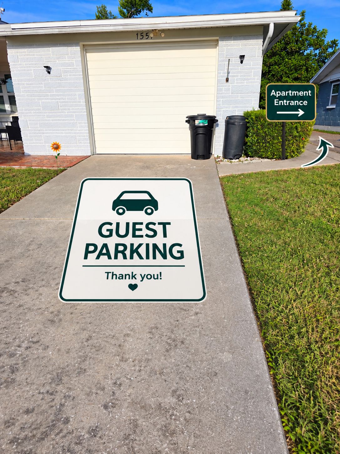A guest parking sign with a car icon and the text 'GUEST PARKING Thank you!' in front of a building with a garage door marked '155'.