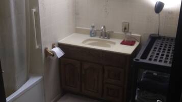 A small bathroom with a toilet, sink, and mirror.