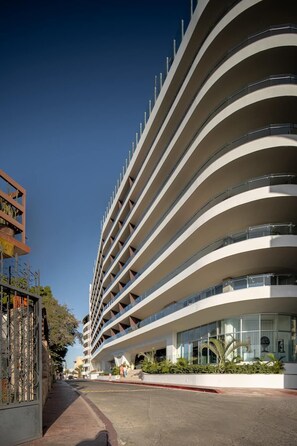A modern hotel with multiple floors and balconies. - corazone cabo 3-bedroom condo with jacuzzi (Cabo San Lucas)