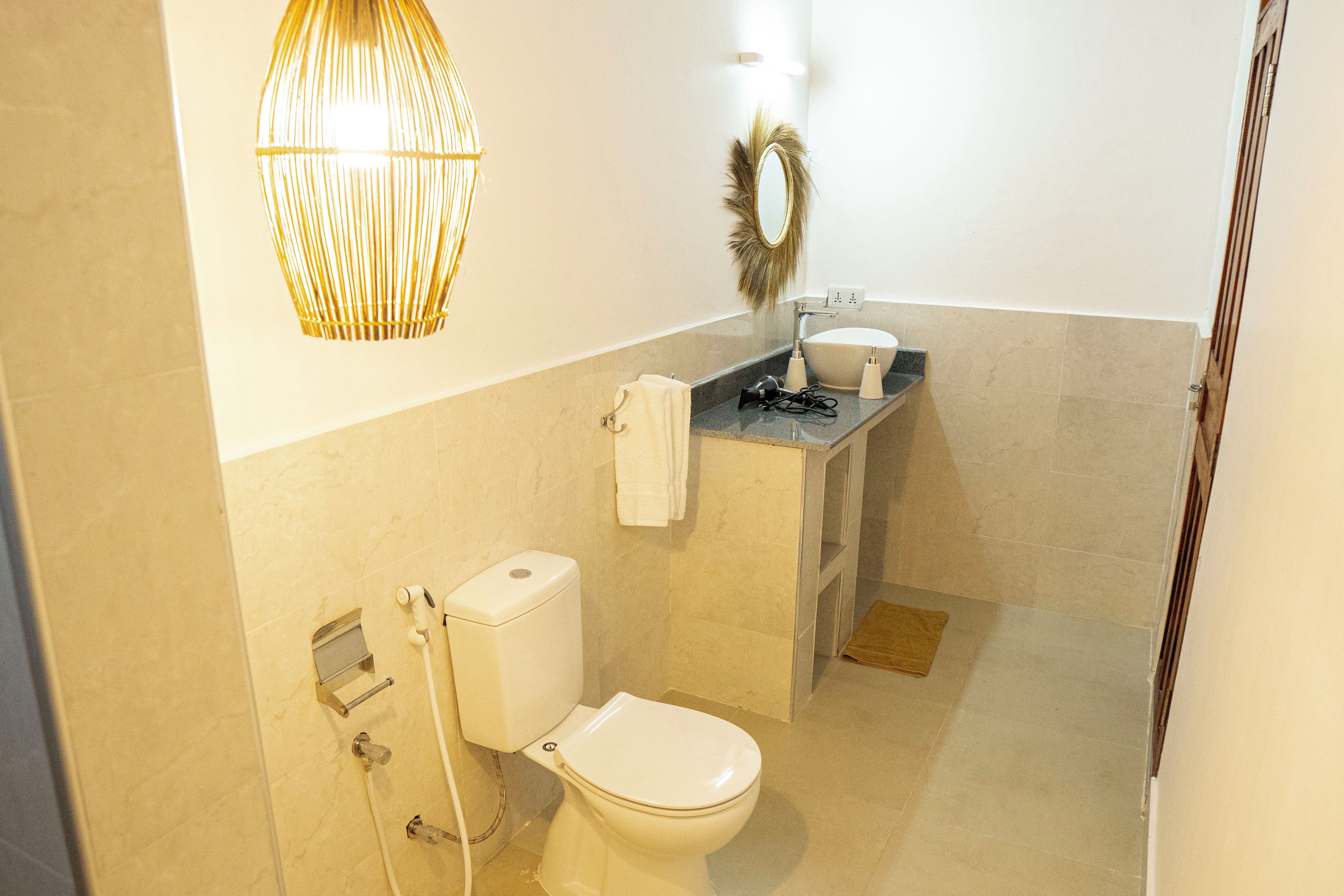 A bathroom with a toilet, sink, and shower.