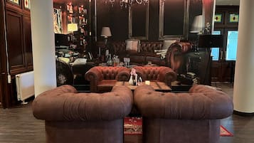 Unwind into leather sofas with candlelit, club-style ambiance.