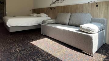 Relax under skylights in a loft-style suite with sofa.