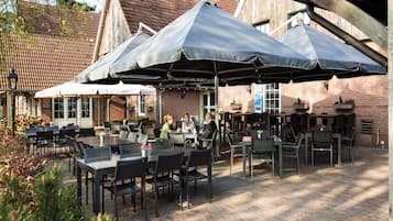 Settle in for drinks and conversation beneath shaded umbrellas.