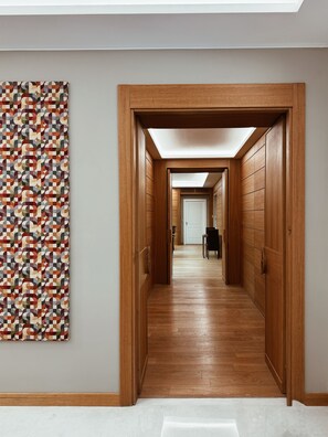 A hallway with wooden paneling and a geometric patterned wall. - Residenza Traiana (Rome)