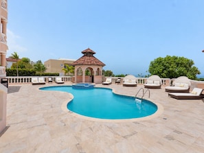 A swimming pool with lounge chairs and a gazebo. - Hospitality Expert VSV TF 3BR Chef Pool  (Montego Bay)