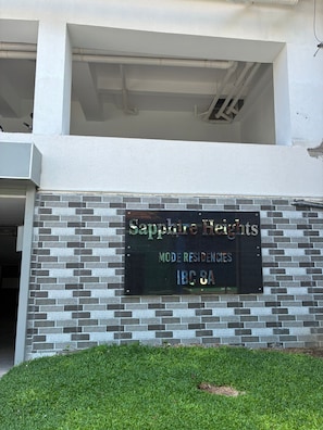 A sign for 'Sapphire Heights' indicating it is a modern residence community with an address of 'IBC 8A'.