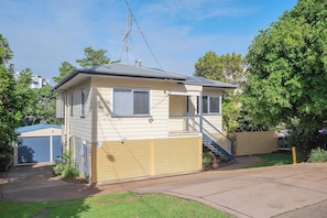 A single-story house with a small porch, a visible antenna, and a garage door. - Verney Beachside Getaway Two (Kings Beach)