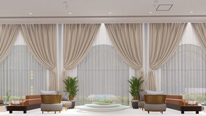 A modern lounge area with a sofa set, a coffee table, and potted plants. - Zone Connect by The Park Mathura  (MATHURA)