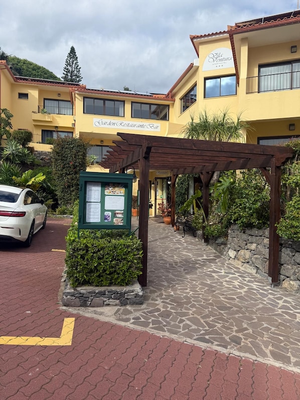 A hotel with a garden restaurant bar, a pergola, and a stone pathway. - Vila Ventura (Santa Cruz)