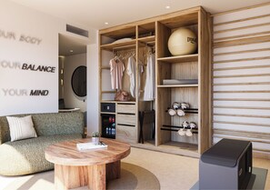 A modern living room with a round wooden coffee table, a sofa, and a wardrobe with a mirror. - HD Sensarena (Teguise)