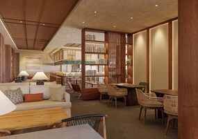 Una biblioteca moderna con estanterías, un sofá, sillas y una mesa de madera.