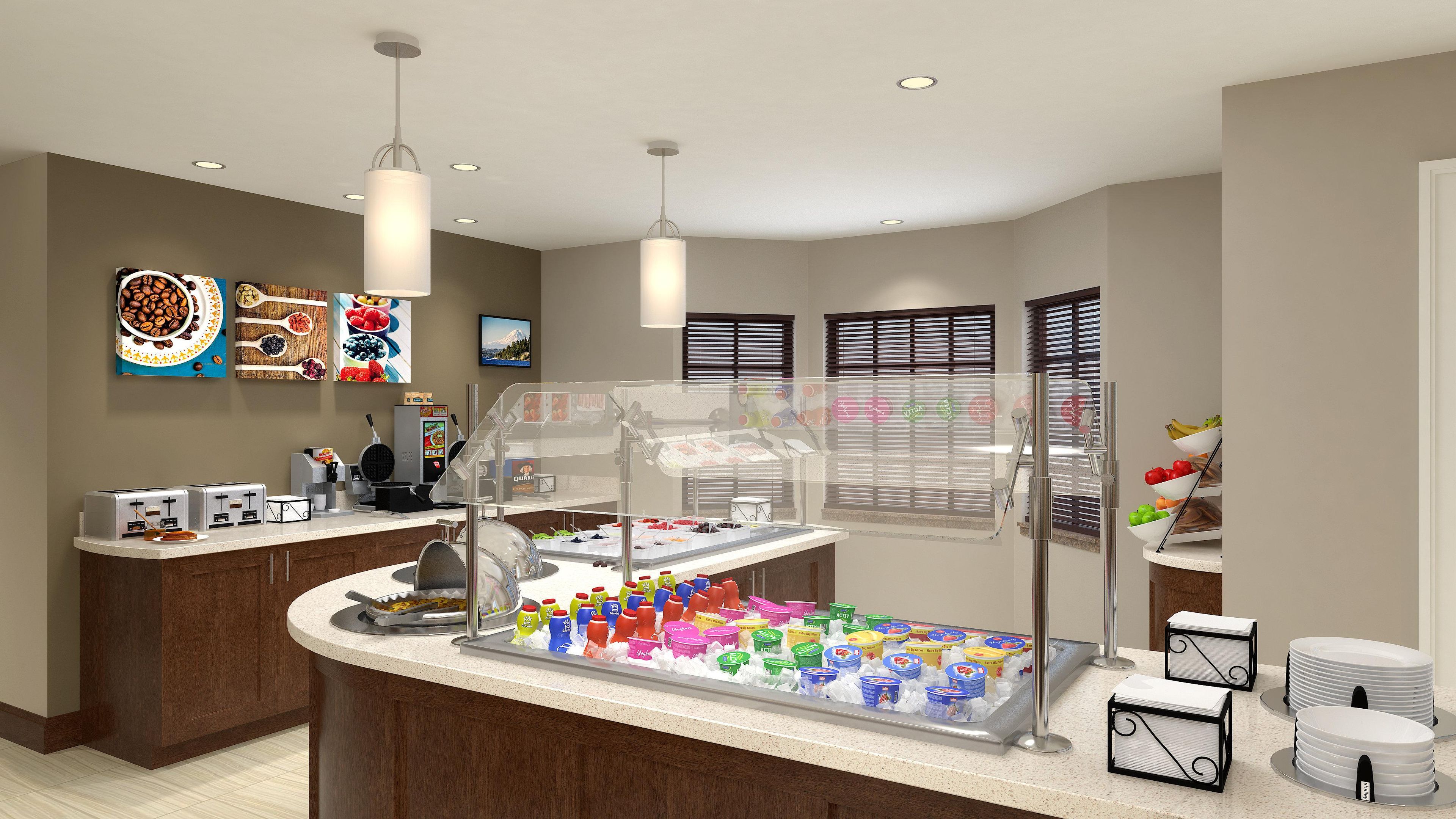 A breakfast bar with a variety of food items, a waffle maker, and a coffee machine.