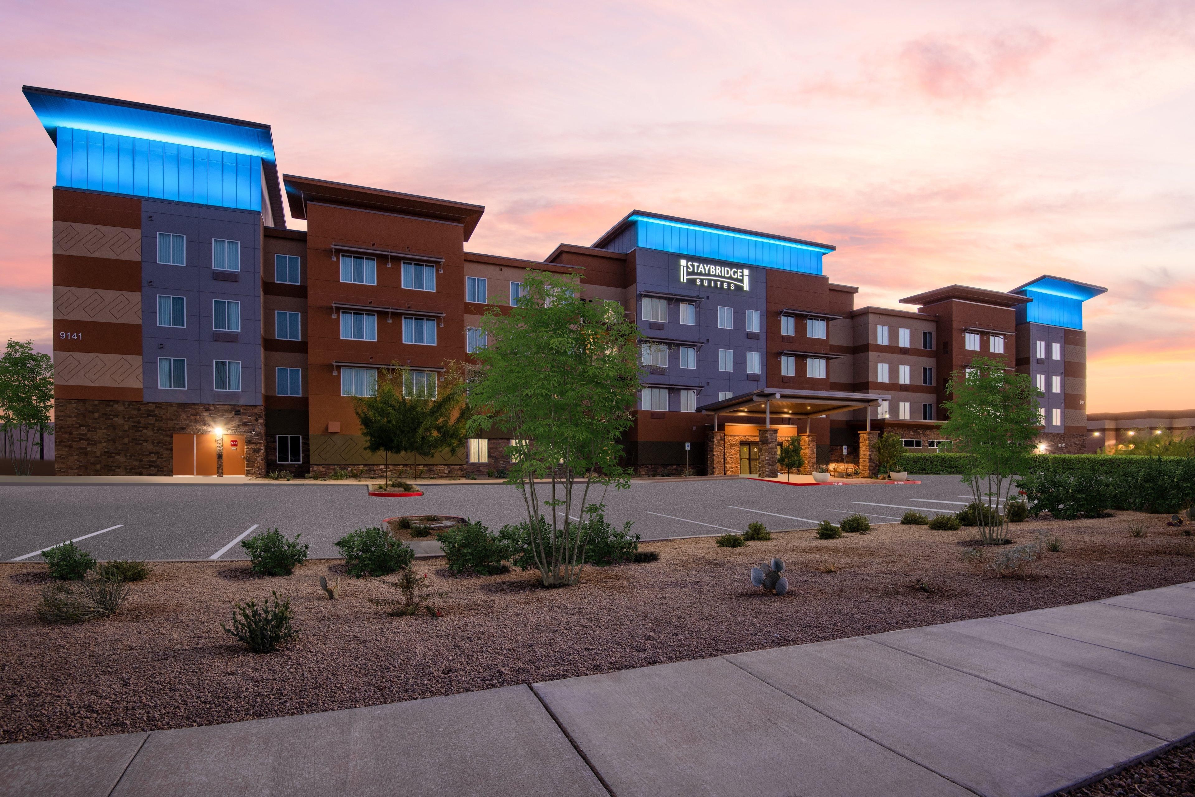 A multi-story hotel with a modern design, featuring a prominent Staybridge Suites sign.