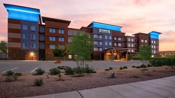A multi-story hotel with a modern design, featuring a prominent Staybridge Suites sign.