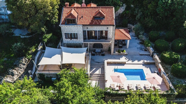A large two-story house with a swimming pool, outdoor seating, and a garden. - Villa Franica (Dubrovnik)
