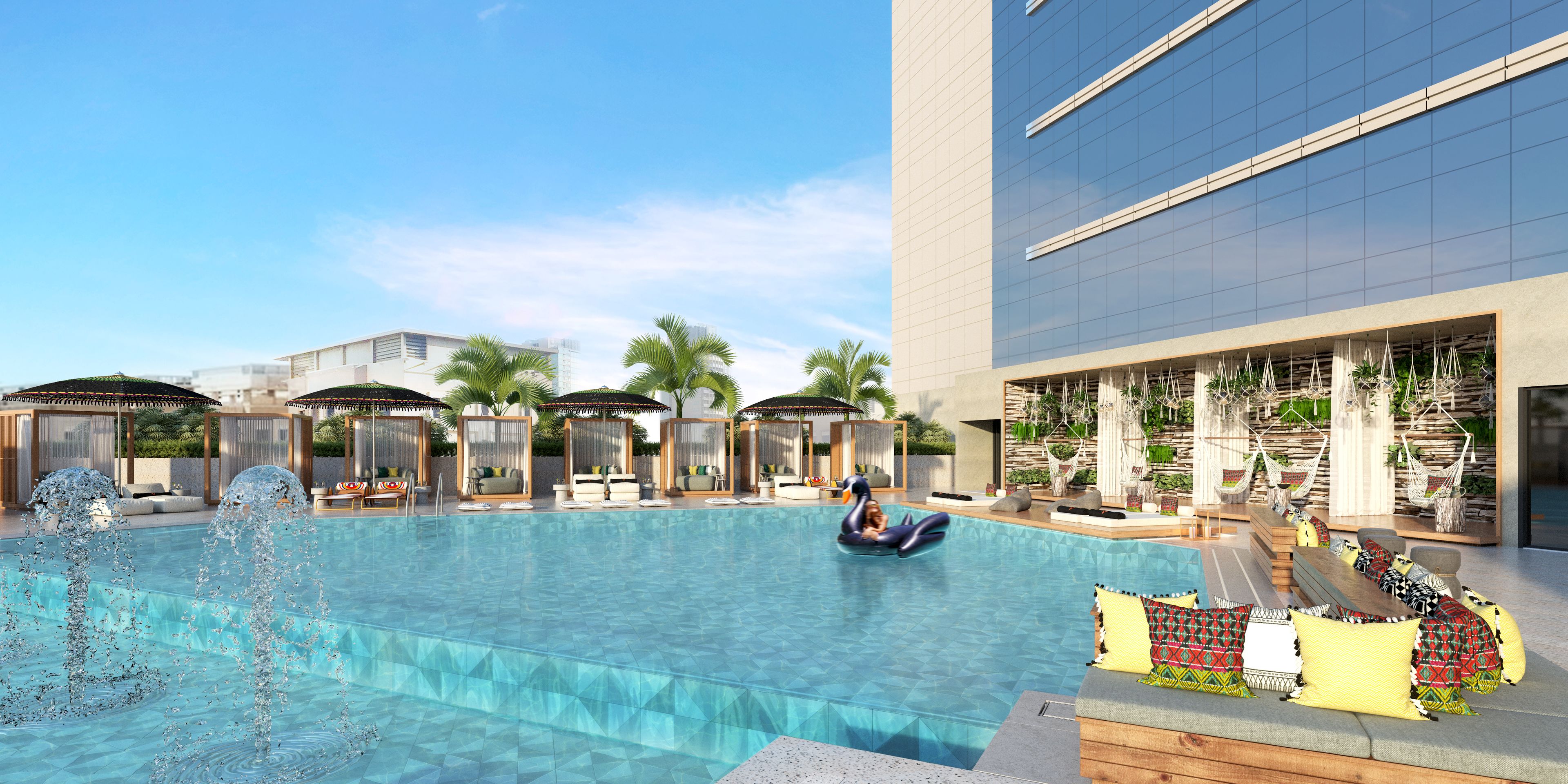 A modern hotel pool area with lounge chairs, umbrellas, and a clear blue pool.