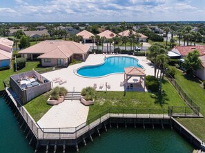 A residential area with a swimming pool, a dock, and a gazebo. - Sea Place 13137 2 Bedroom Condo (St. Augustine)