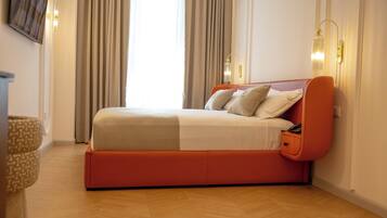 A modern bedroom with a bed, curtains, and a wall-mounted light fixture.