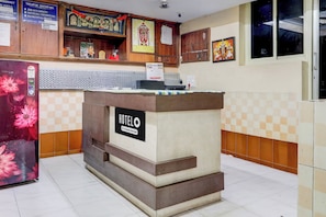 A reception desk with a sign indicating it's a company-serviced hotel.