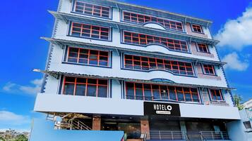 A multi-story hotel with a prominent 'HOTEL' sign at the ground level.