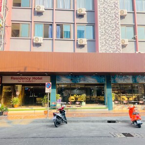 Edifício com placa indicando 'Residency Hotel' e placa de proibido estacionar.