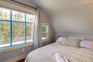 A bedroom with a large window, a bed with white bedding, and a headboard. - Quiet Countryside Escape w/ Views in Talking Rock (Talking Rock)
