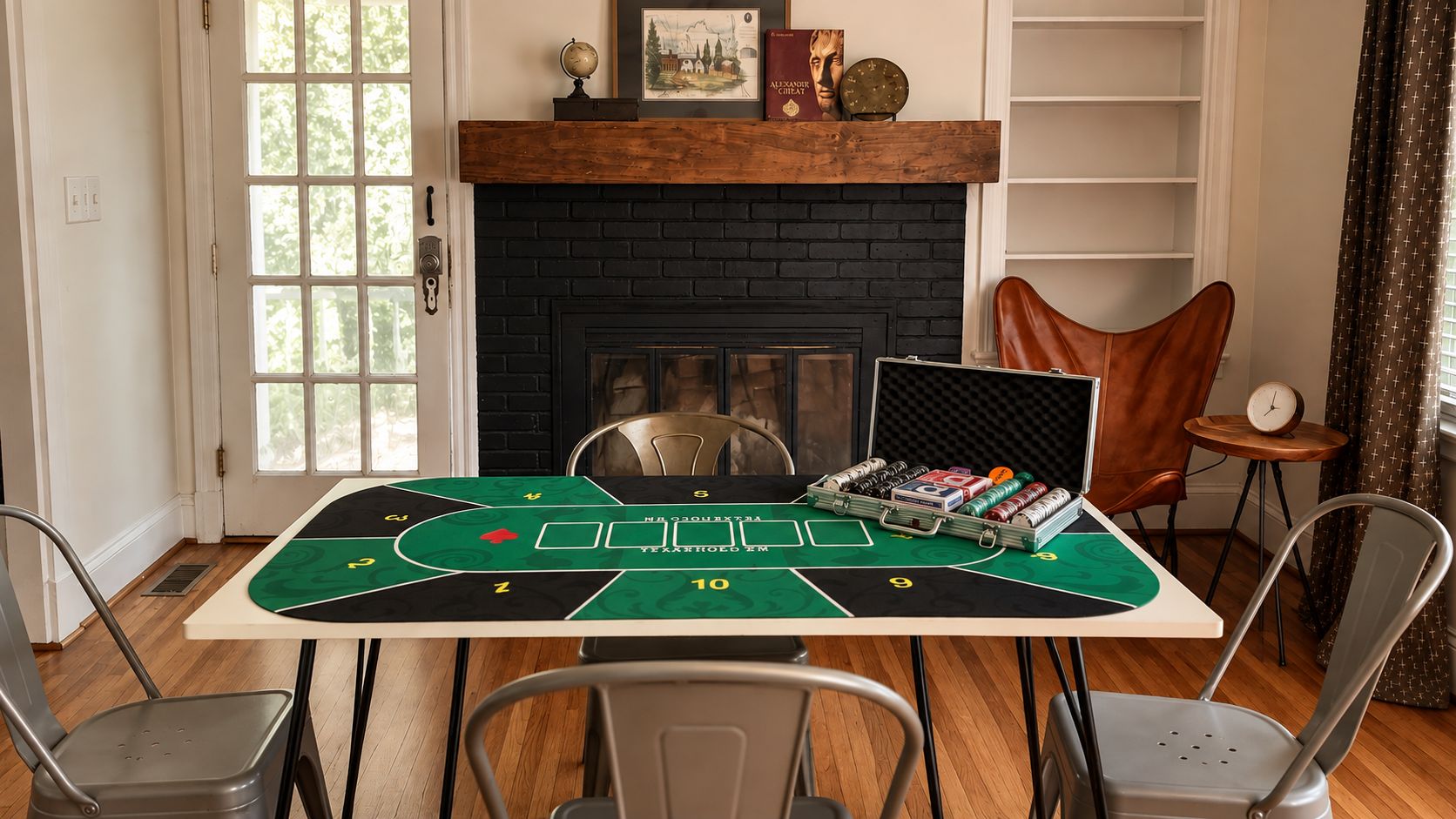 A room with a poker table set up for a game, a fireplace, and a bookshelf.