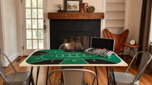 A room with a poker table set up for a game, a fireplace, and a bookshelf. - Renovated haymount home, less than 10 min from I-95 (Fayetteville)