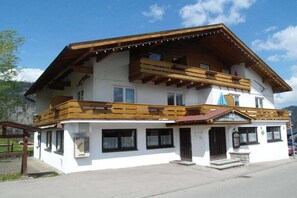 A two-story building with a wooden balcony, a sign indicating a restaurant, and a clear sky. - Allgäu Hearts 1 and 2 (Kornau\/Oberstdorf)
