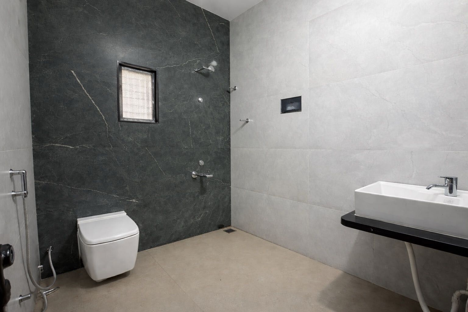 A bathroom with a toilet, a shower, and a sink.
