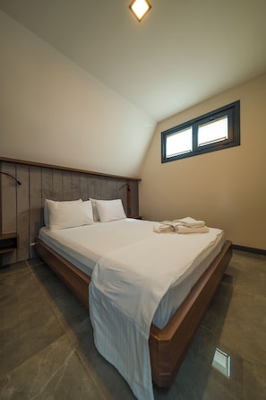 A bedroom with a bed, a nightstand, a window, and a ceiling light. - TIMELESS KARTEPE (Kartepe)