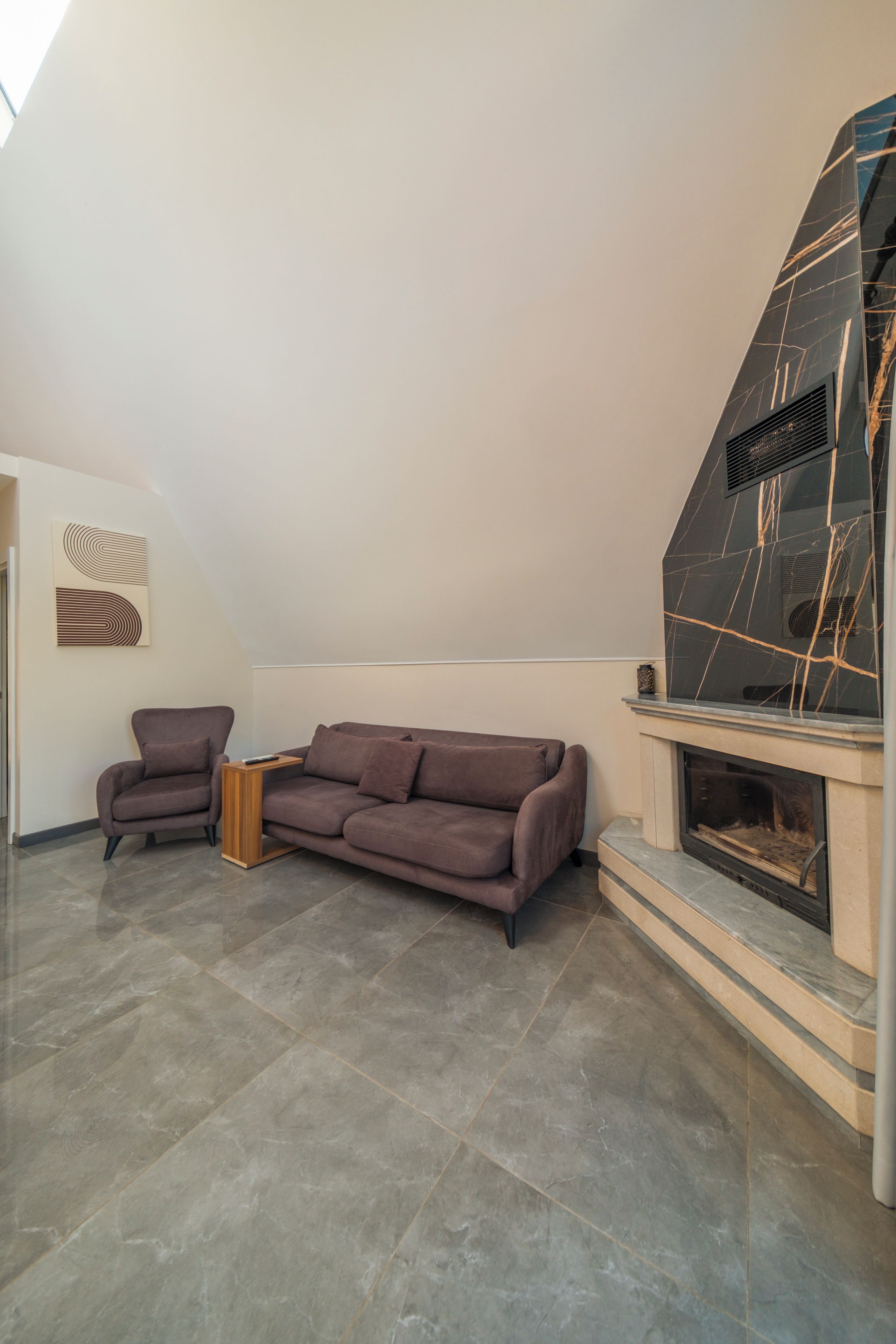 Ein modernes Wohnzimmer mit einer Eckcouch, einem Kamin und einem minimalistischen Design.