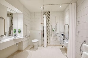 A modern bathroom with a shower, toilet, and sink. - Silverstone (South Northamptonshire District)