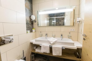 A modern bathroom with a dual sink, a large mirror, and a telephone. - Aigo welcome Family  (Aigen-Schlägl)