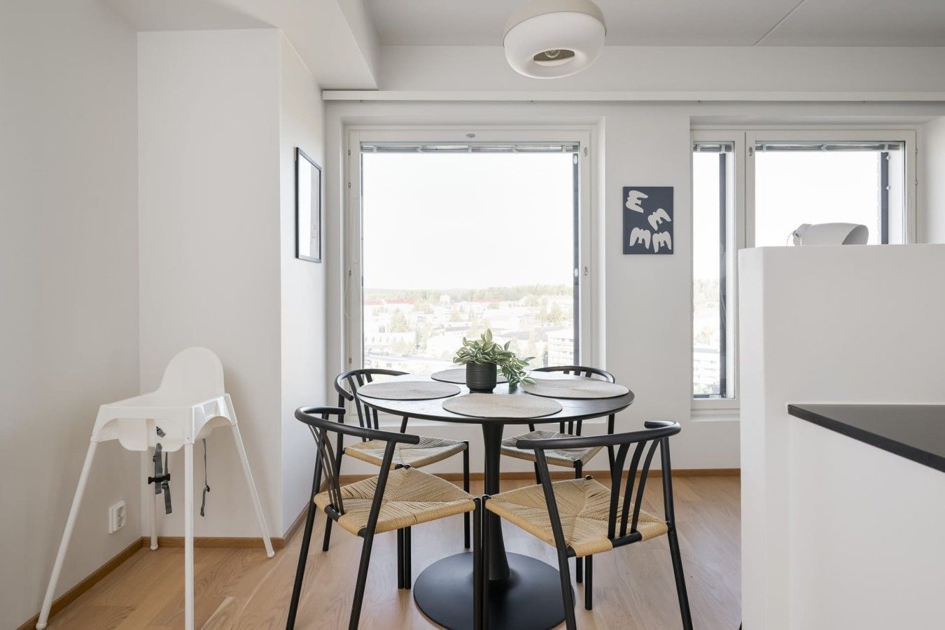 Una cocina moderna con comedor, ventanas amplias y vistas a la ciudad.