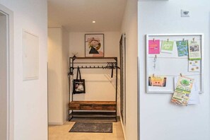 A hallway with a bunk bed, a framed bulletin board with notes, and a door on the left. - Black Forest jewel terrace flair (Bonndorf im Schwarzwald)