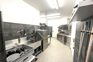 A modern kitchen with stainless steel appliances, a sink, and a stove.