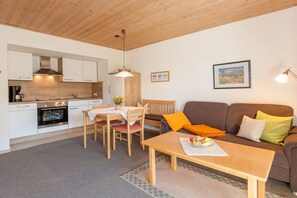 Een knus verblijf met een kitchenette, een eethoek en een zithoek.
